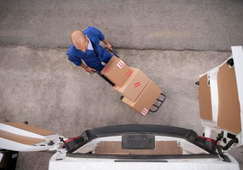 full-shot-delivery-man-carrying-boxes-top-view_23-2149103412
